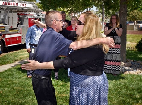 Dave Tompkins gets a hug from Amber Cooper as they meet for the first time in front of Cooper’s home in Anaheim. 