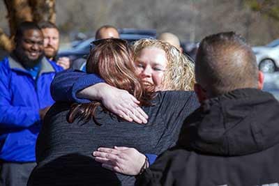 Christie Sanders gives Amanda Esbrandt the ADT Dispatcher who called her a well deserved hug.