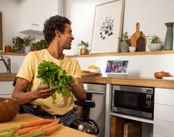 Man using his Google Nest Hub Max to see his live Google Nest Cam footage