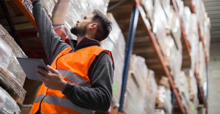 Man in warehouse checking inventory