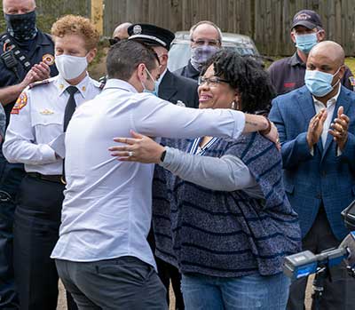 A well deserved hug between ADT Care agent Manny Rojas and Zina Henry.