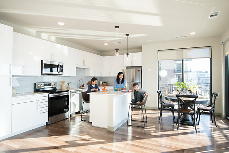 Mother with her two children in the kitchen