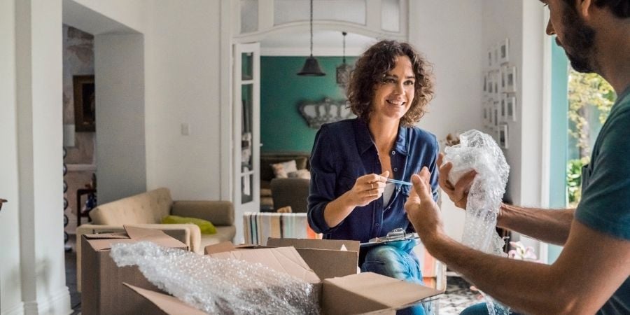 Couple unpacking moving boxes