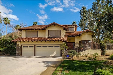 Two story single family house with an ADT sign out front