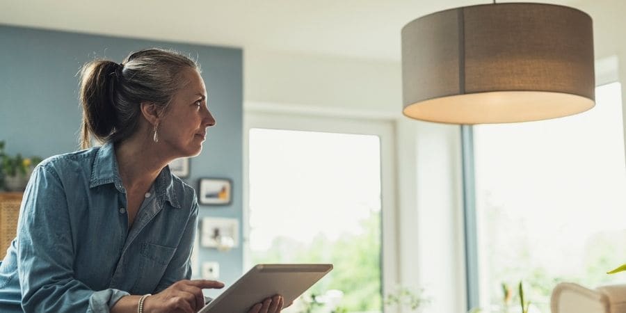 Woman controling smart home with tablet 